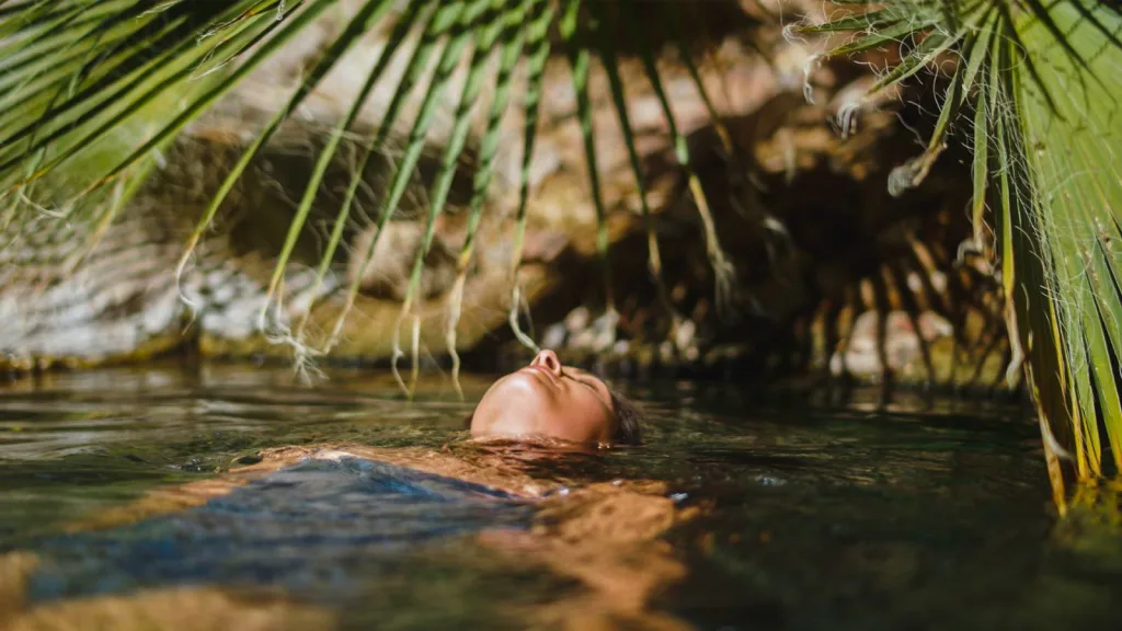 Meditating woman floating at Castle Hot Springs